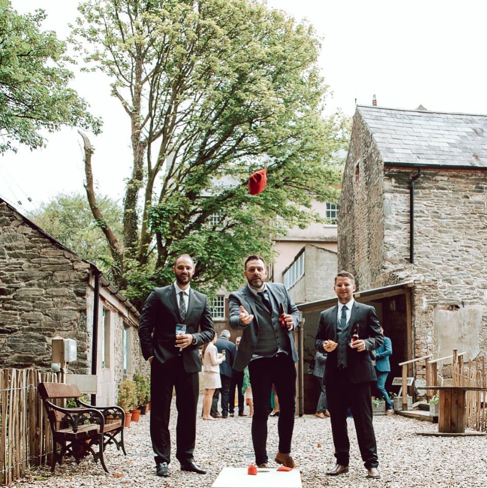 Guests playing garden games in the stone courtyard at Dunmore